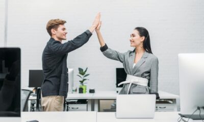 multiethnic business partners giving high five at office